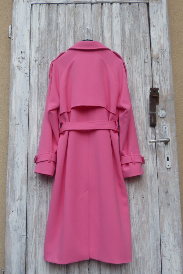 Oversize woman trench coat with decorative flaps on shoulders.