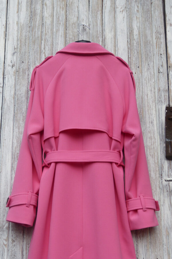 Pink color coat with belt and ornamental button tabs at the cuffs and on the shoulders.