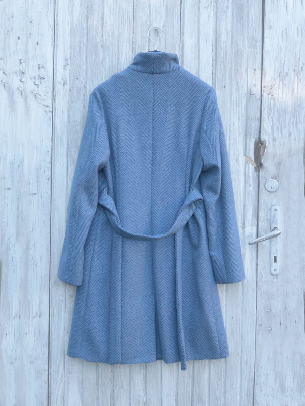 Wysoko zapinany zimowy płaszcz w jodełkę. Dopasowany krój, asymetryczny przód, wiązany w pasie. Idealny płaszcz zimowy.