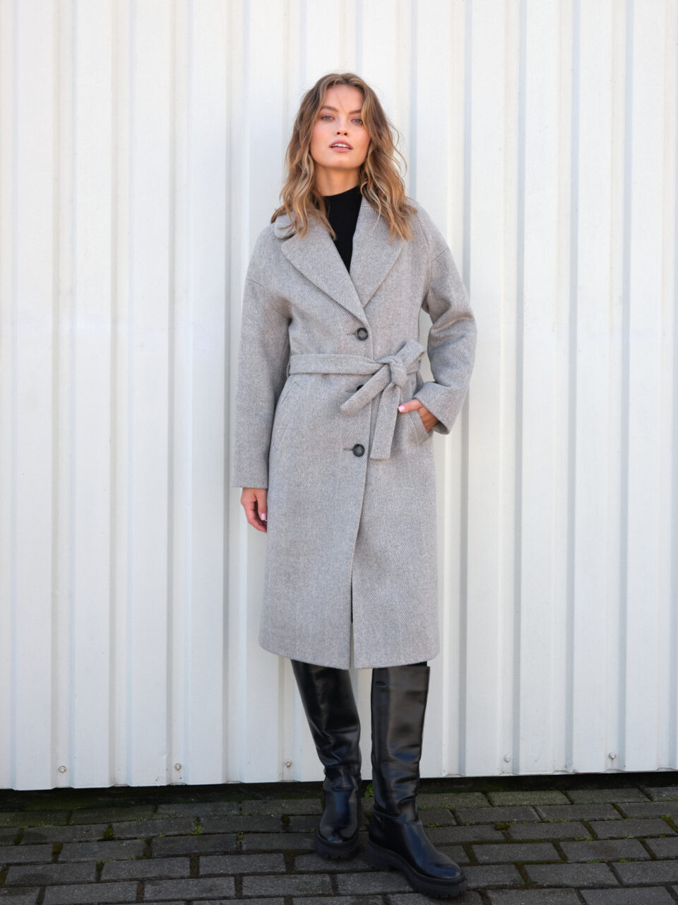 Lużny płaszcz zimowy w szaro-beżową jodełkę. Długość midi, raglanowy rękaw, wiązany. Ocieplany.